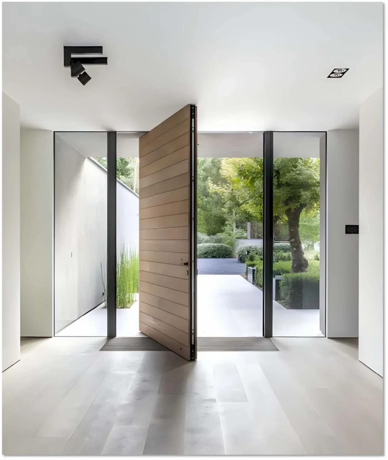 Interior Door 4 Luxury modern pivot entry door with a sleek wooden finish, surrounded by floor-to-ceiling glass panels, offering an elegant and contemporary aesthetic.